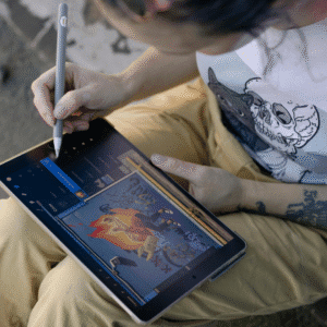 Tattoo artist sketching a digital design on a tablet, illustrating tattoo scheduling app tips for efficient client management.