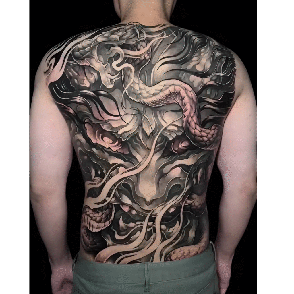 Full back Japanese dragon tattoo in black and grey with pink highlights