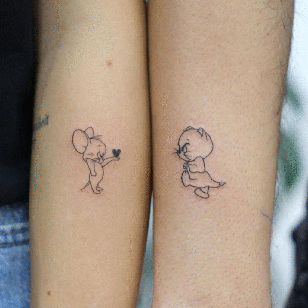 Matching tattoo ideas for friends featuring Tom and Jerry outline designs on forearms