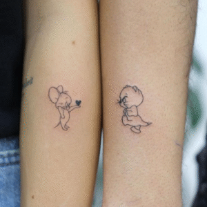 Matching tattoo ideas for friends featuring Tom and Jerry outline designs on forearms
