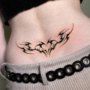 Lower back tribal tattoo with heart-shaped design – book tattoo appointment online