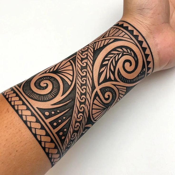 Maori Tribal Forearm Tattoo – Polynesian Symbolism & Patterns Polynesian tribal tattoo sleeve on forearm with traditional Maori patterns and bold black ink