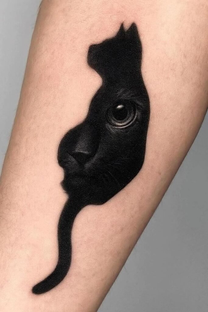 Black Cat Silhouette Tattoo – Bold Blackwork Design Blackwork cat silhouette tattoo with realistic eye detail on forearm