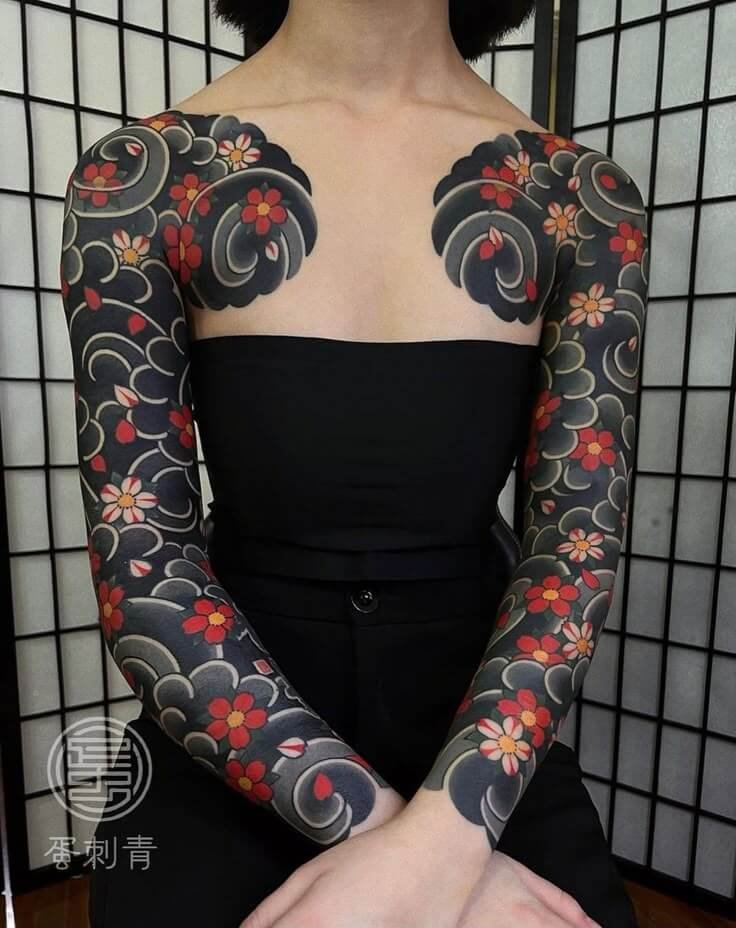 Traditional Japanese floral blackwork tattoo sleeves showing heritage and cultural symbolism – tattoo symbolism in pop culture
