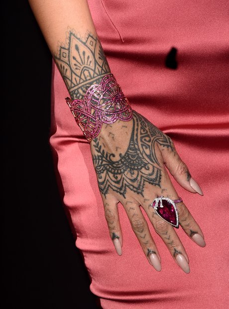 Rihanna’s intricate hand tattoo with mandala pattern representing spirituality and power – tattoo symbolism in pop culture