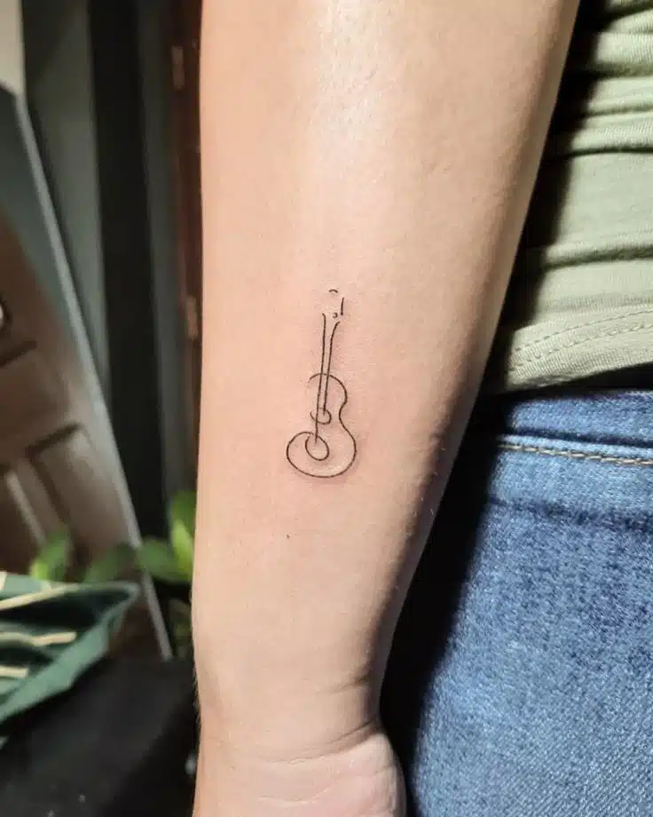 minimal line art guitar tattoo on forearm for music lovers