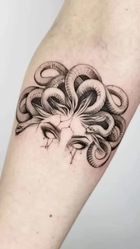 realistic medusa mythology-inspired tattoo with snakes and stone eyes on forearm